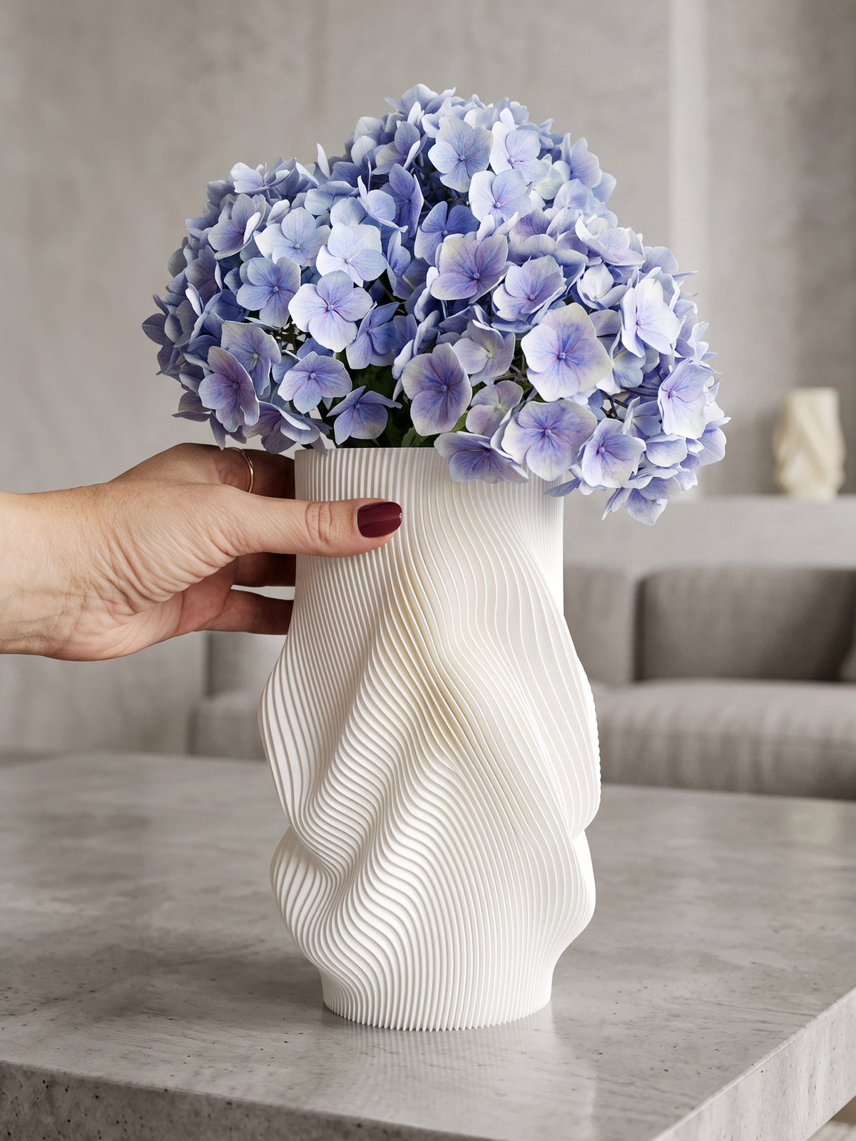 White AQUA FLOW sculptural 3D printed vase with blue hydrangeas and elegant wave-shaped texture