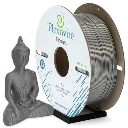 Silver PLA filament Plexiwire 1.75 mm on a cardboard spool with a 3D-printed gold Buddha figurine